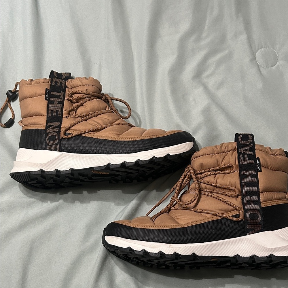 The North Face women’s Brown and Black Rain Boots